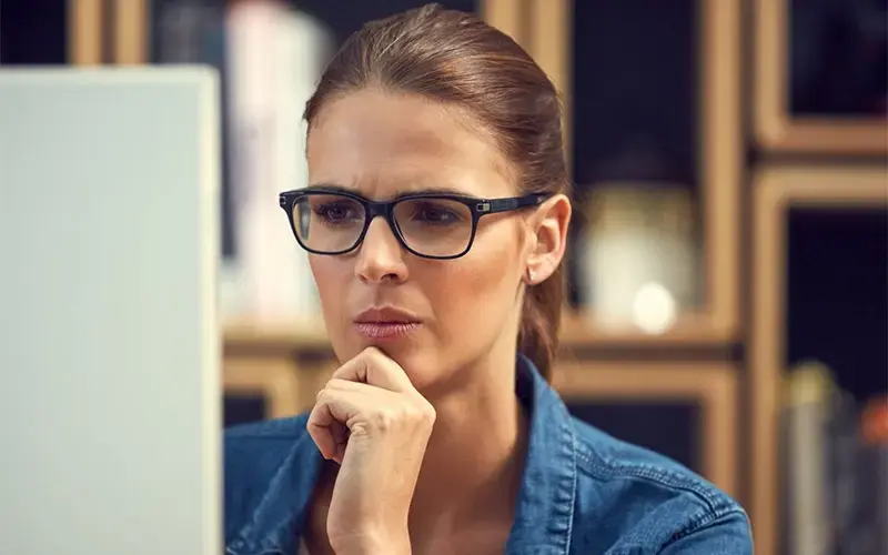 Woman reviewing information on a computer while considering a digital marketing agency