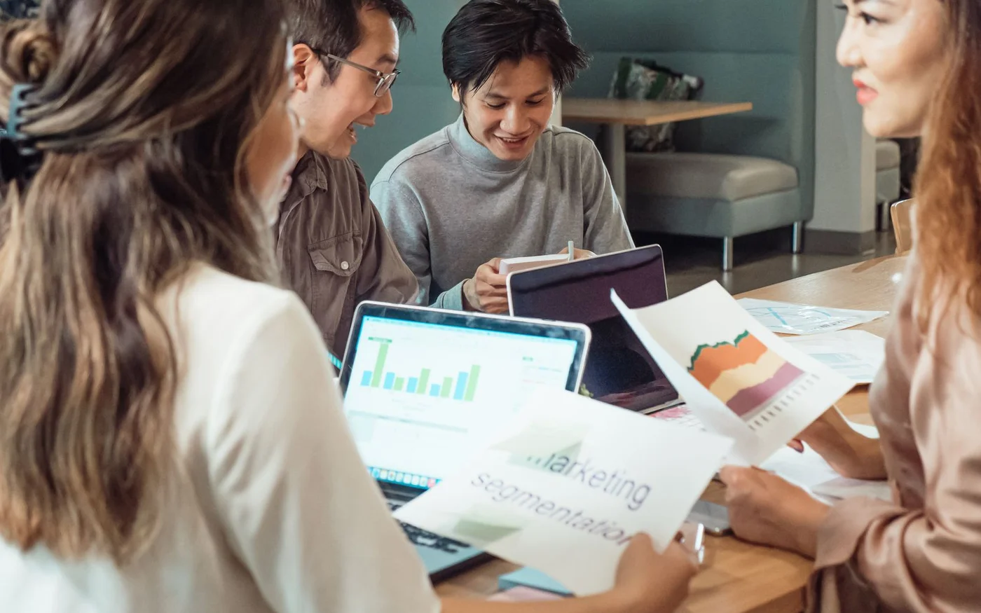 Marketing team reviewing charts and campaign strategy during an agency planning meeting